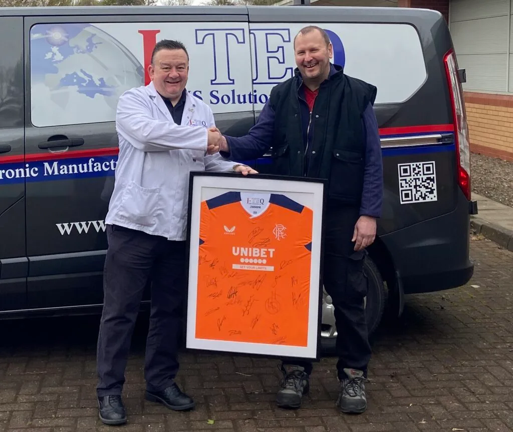 Michael Page presenting Jason Rae with a gift for 25 years of service